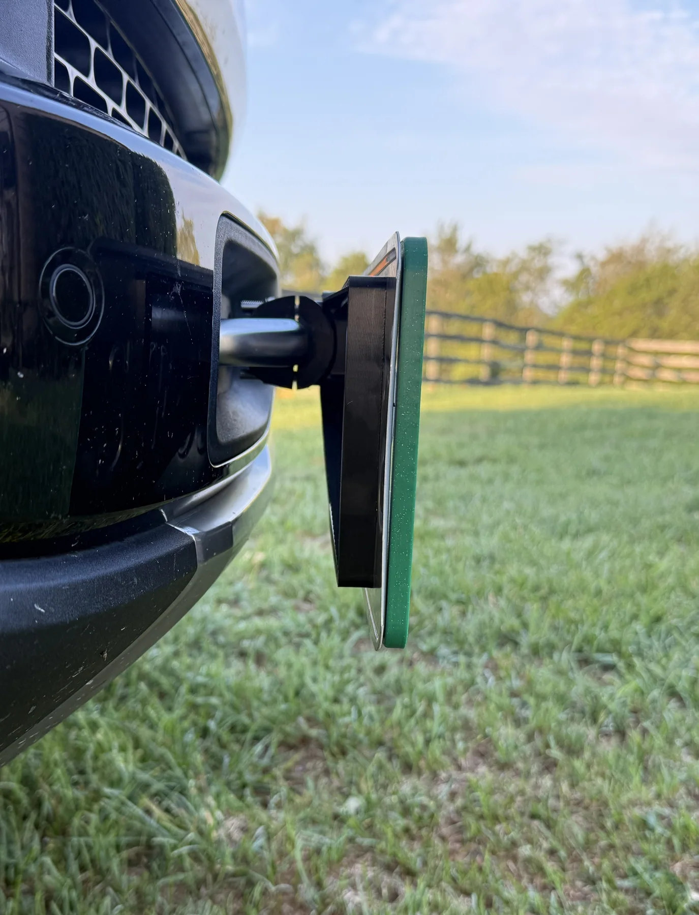 Side view of KT-26 tow hook mount showing offset license plate positioning on Rivian R1T