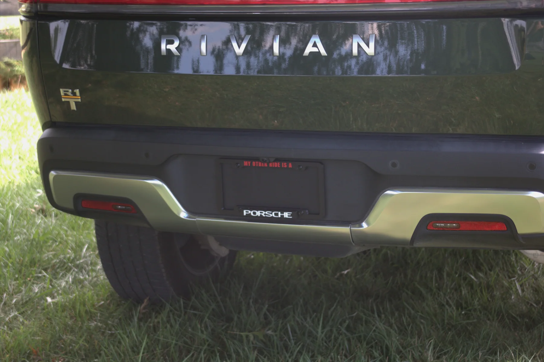 Close view of a KT-34 magnetic personalized license plate frame installed on a vehicle